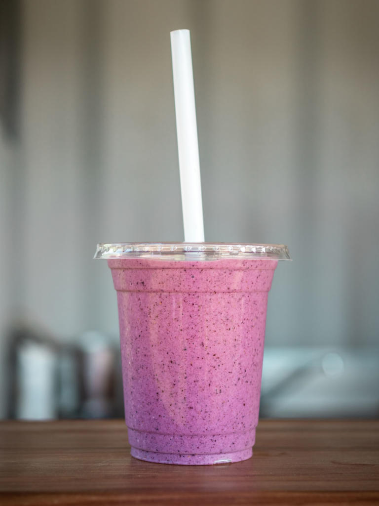 juicy blackberry smoothies in glass bottles Stock Photo by nblxer